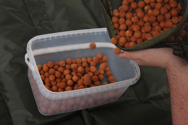 01 Start by tipping the air-dried baits into a bucket or container.